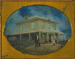 Square house, man, child and dog on lawn