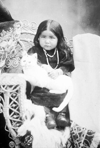 Nez Perce girl with cat, Idaho, ca.1899.