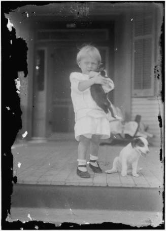Child (boy) with cat and dog. Photograph by Robert Runyon.
